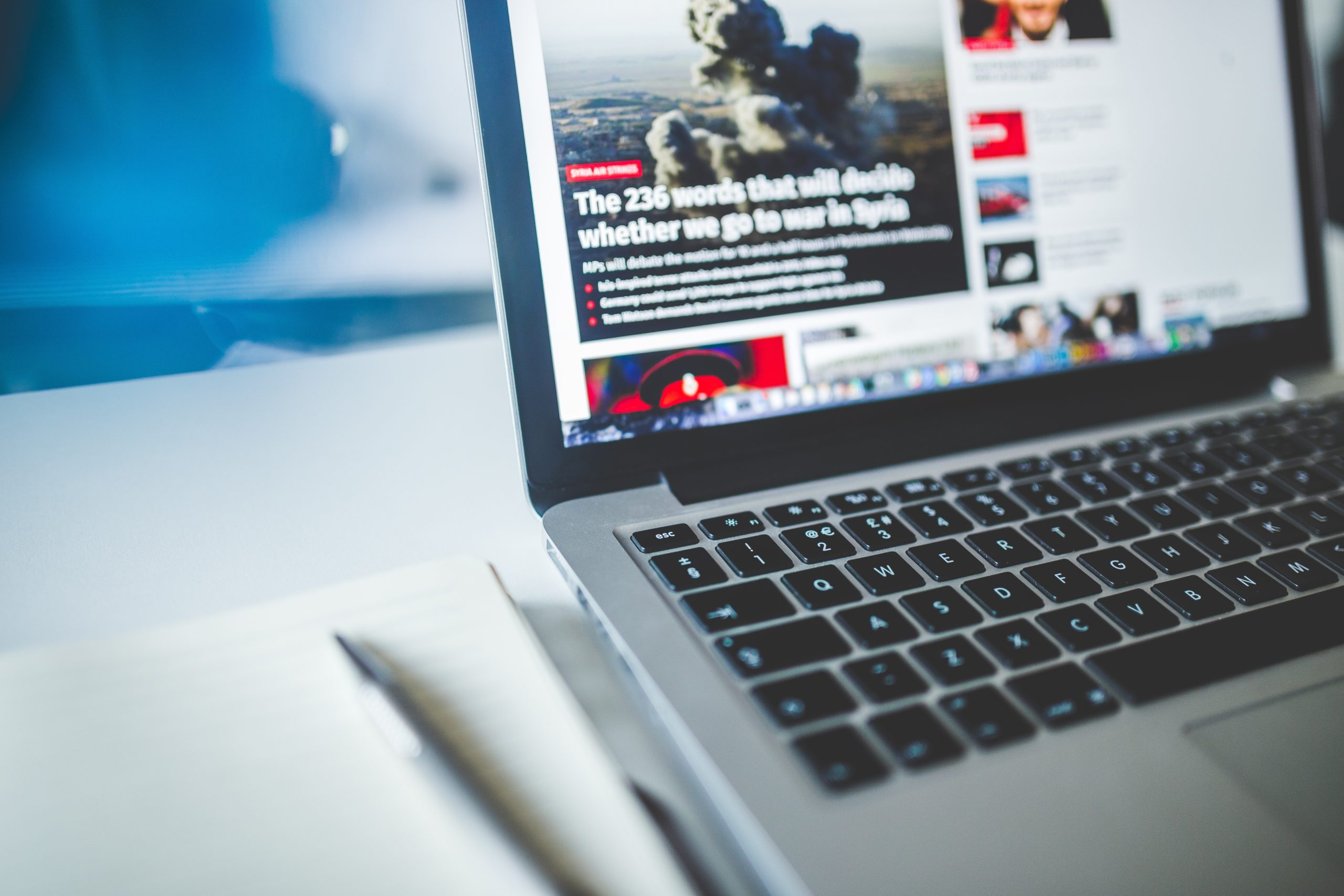 grey laptop featuring the news
